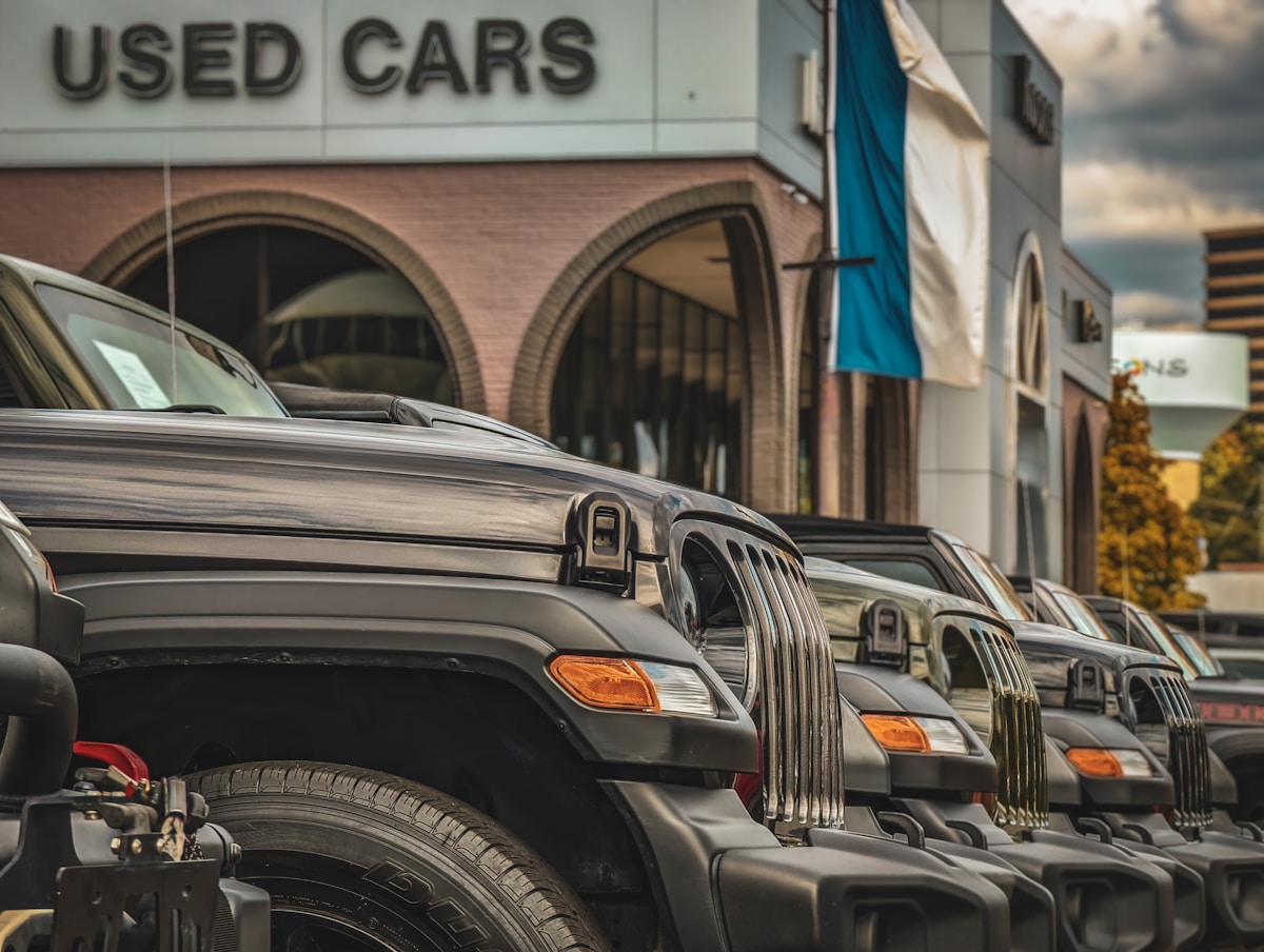 Used cars lined up outside a dealership